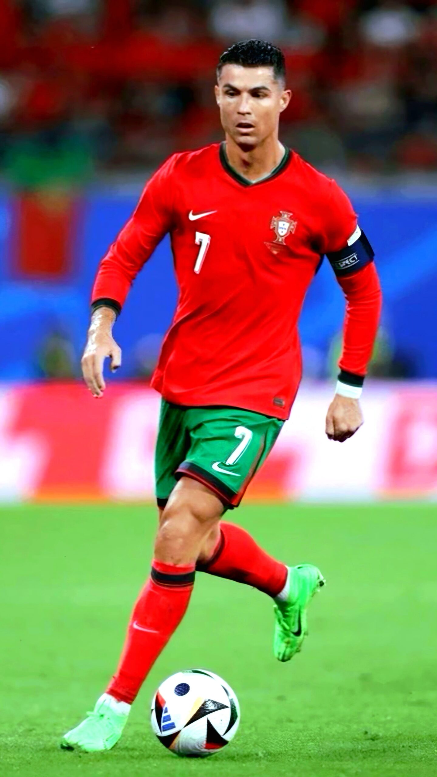 A soccer player in a red Portugal jersey with number 7 and a captain’s armband runs on the field, focused on the ball at his feet, as fans around the world tune in via Croatia IPTV to catch every thrilling moment.